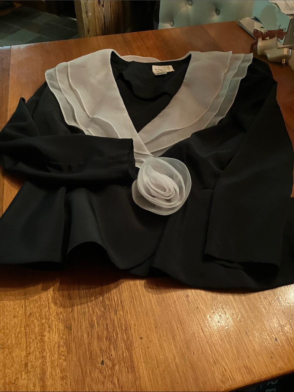 Black Blouse with White Sheer V-Collar and Rosette Accent